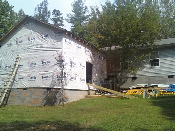 Tyvek wrapped gable on a new room addition beside an existing home in Orbisonia