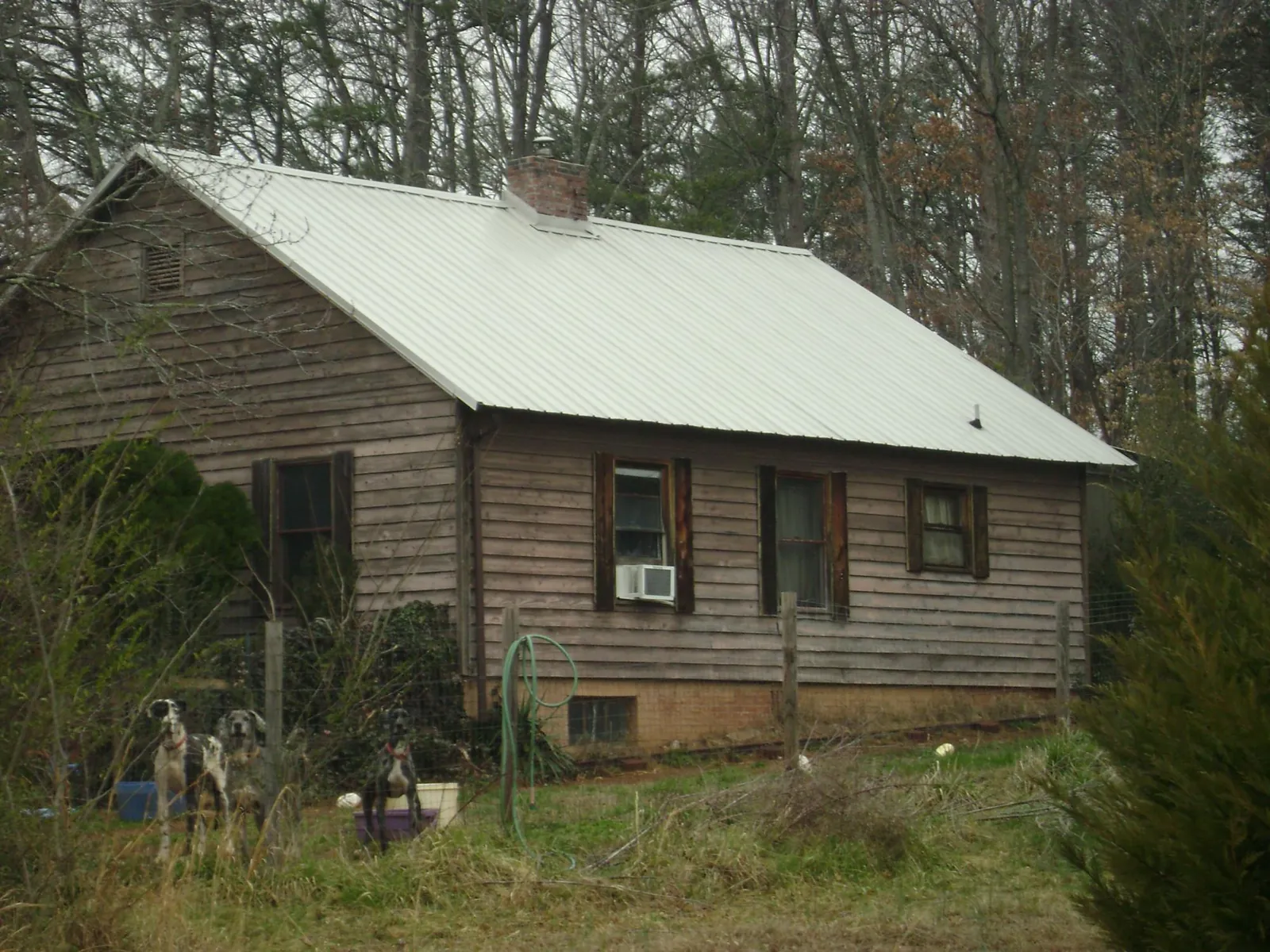 White metal roof on an old wood sided farmhouse, from a Metal Roof Installation job in Orbisonia